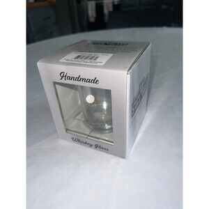 Golf tee stuck in whiskey glass